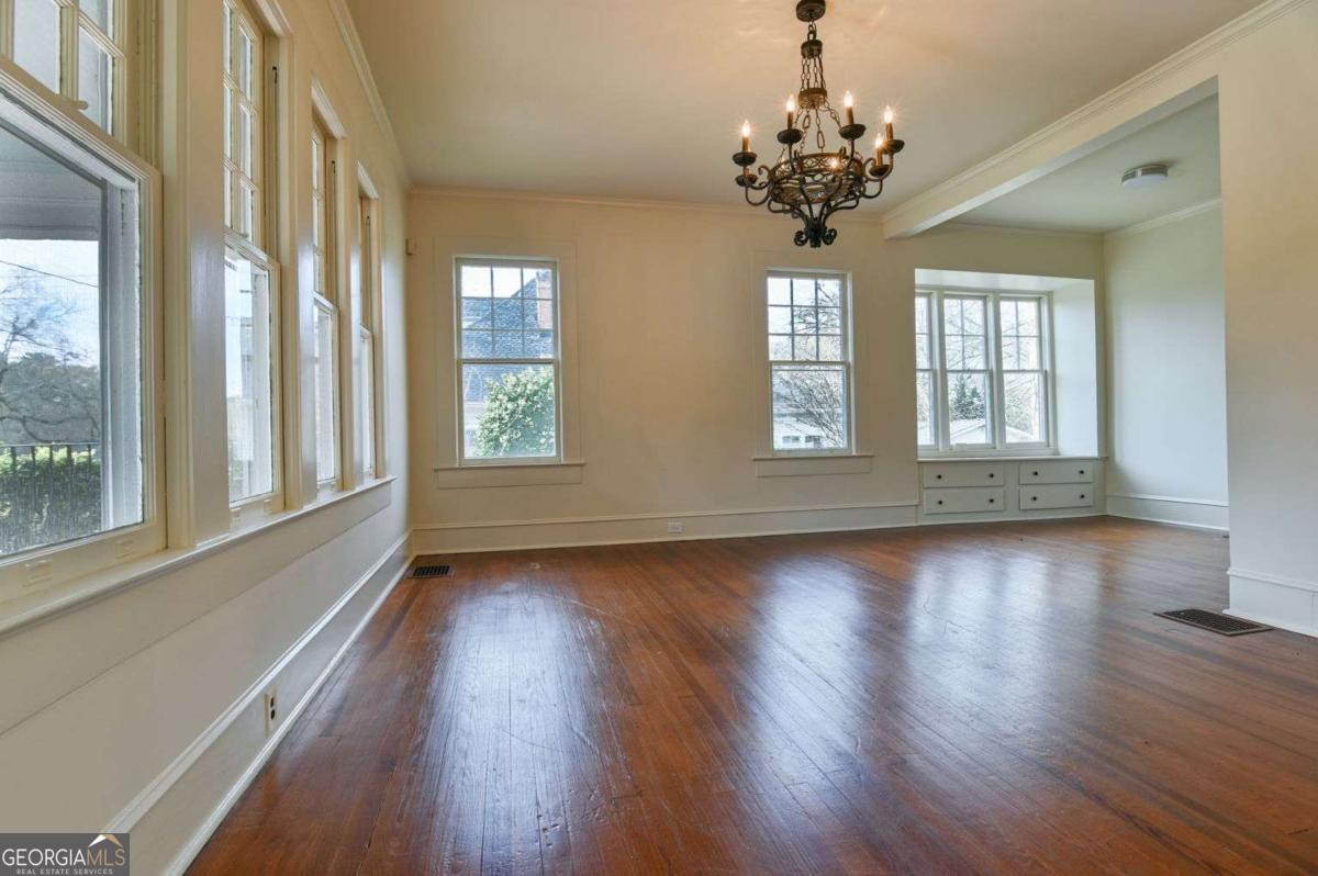 120 Tusten Street Elberton, GA 30635 - Photo 8 of 49 a view of an empty room with wooden floor and a window