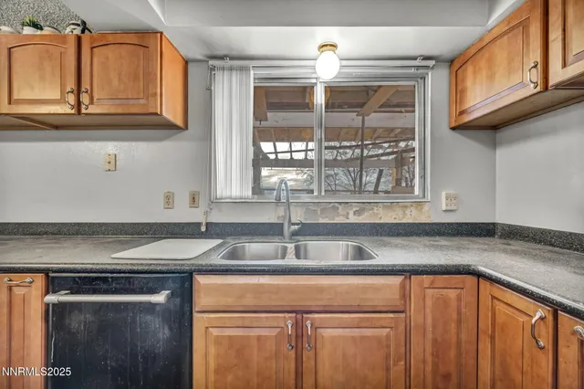 a kitchen with stainless steel appliances granite countertop a refrigerator a sink and a stove