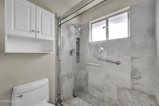 a view of a livingroom with a ceiling fan and window