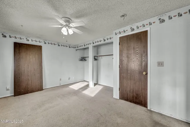 a view of a big room with a ceiling fan and fan