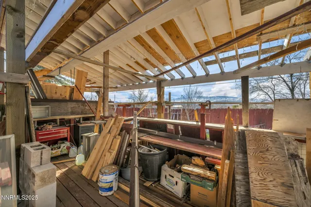 a view of a backyard with table and chairs with wooden fence