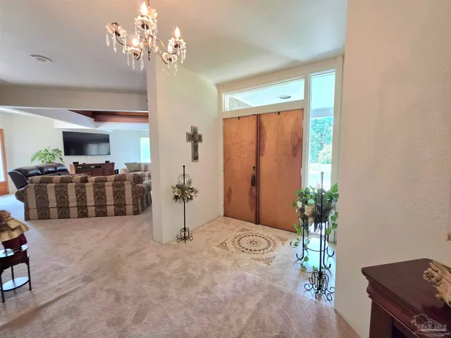 a kitchen with sink a window and cabinets