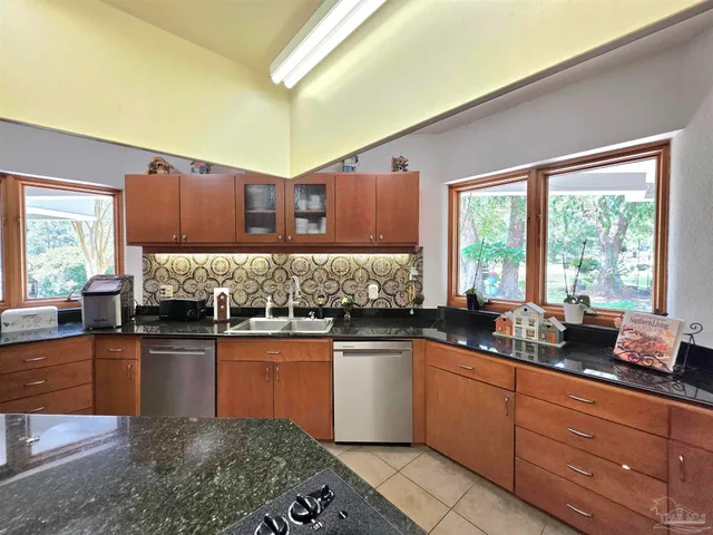 a metallic refrigerator freezer sitting in a kitchen