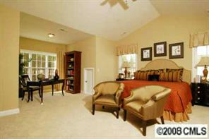 79240 Ridgehaven Road, Unit 141 Lancaster, SC 29720 - Photo 4 of 6 a bedroom with a bed and wooden floor