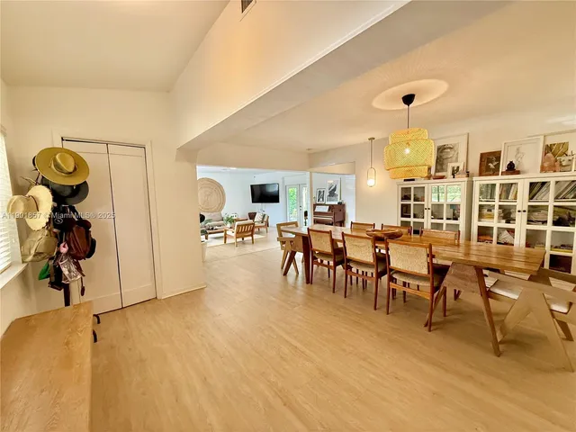 a view of a dining room with furniture and a chandelier