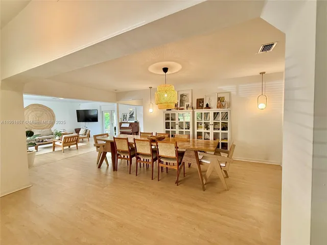 a dining room with furniture and a flat screen tv
