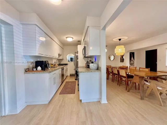 a large kitchen with lots of counter space and furniture