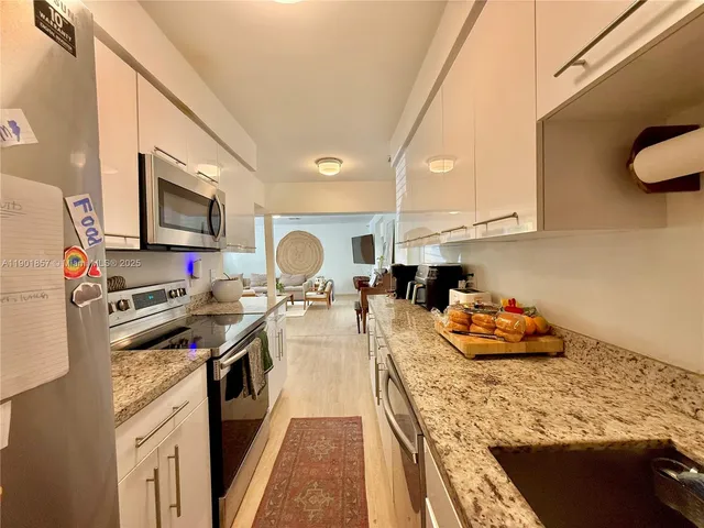 a kitchen that has a lot of cabinets in it