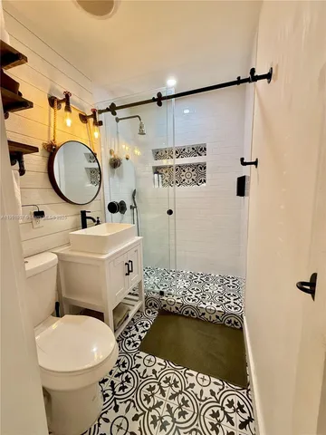 a bathroom with a sink toilet and shower