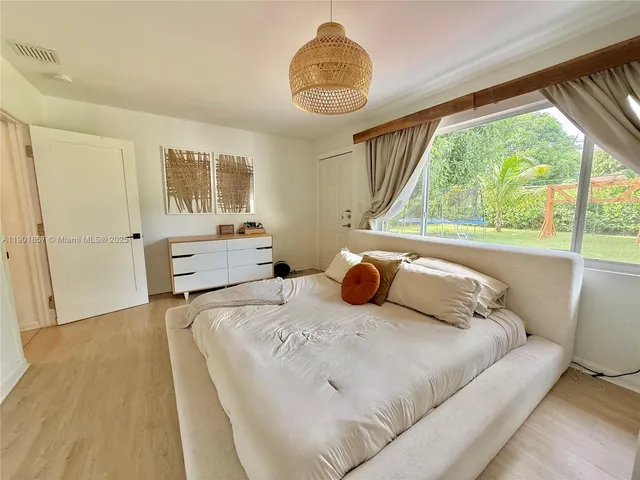 a bedroom with a bed and window