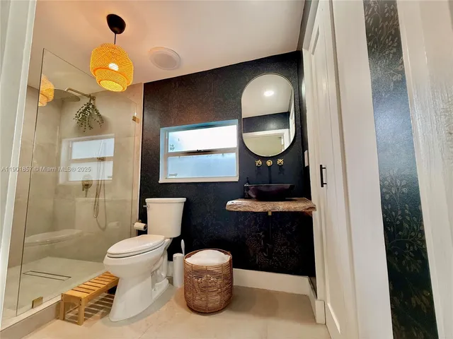 a bathroom with a toilet sink and mirror
