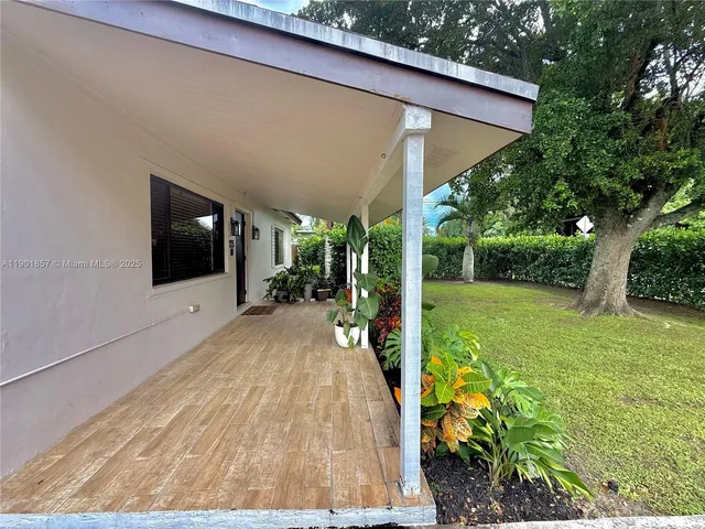 a view of a patio with table and chairs potted plants with wooden floor