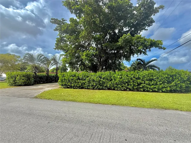 a view of a garden with a building in the background