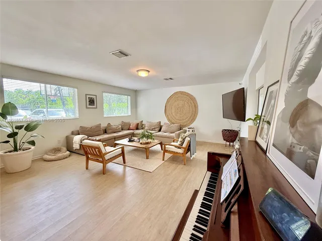 a living room with furniture rug and window