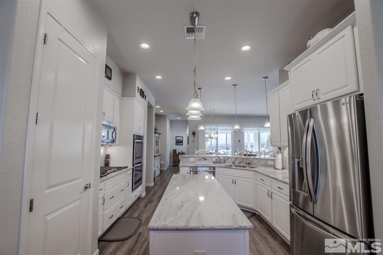 930 Broderick Trail Reno, NV 89523 - Photo 6 of 25 a kitchen with stainless steel appliances granite countertop a refrigerator and a sink