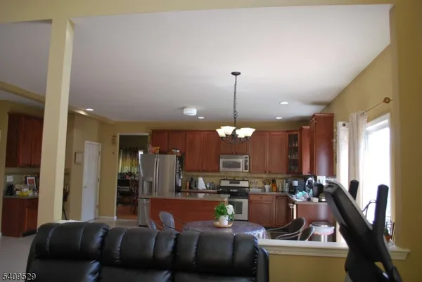 a kitchen with refrigerator cabinets dining table and chairs