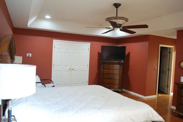 a bedroom with a bed and a television