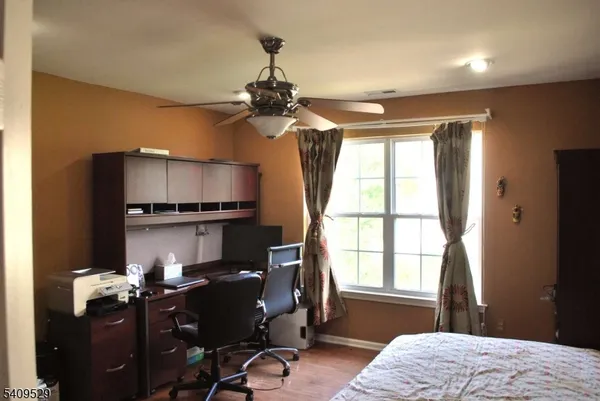 a bed sitting in a bedroom next to a window