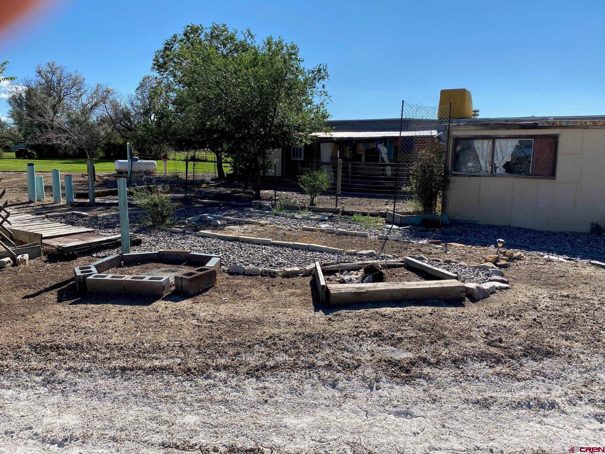 1934 Odelle Road Montrose, CO 81401 - Photo 7 of 10 a view of a house with backyard barbeque and sitting area