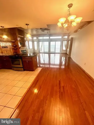 a kitchen with granite countertop a refrigerator and a sink