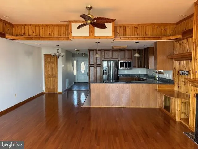 a kitchen with granite countertop a refrigerator and a sink