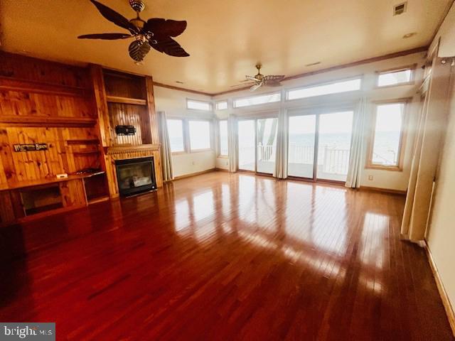 117 Chesapeake Avenue Prince Frederick, MD 20678 - Photo 15 of 65 a view of an empty room with wooden floor a ceiling fan and windows