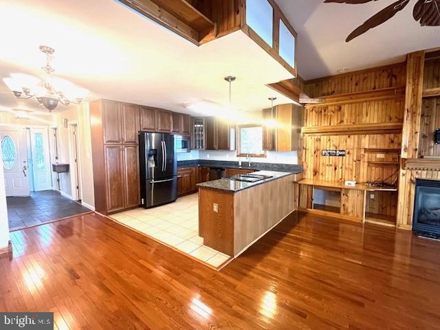 117 Chesapeake Avenue Prince Frederick, MD 20678 - Photo 20 of 65 a kitchen with stainless steel appliances kitchen island granite countertop a refrigerator a stove and a wooden floors