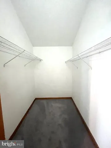 a view of a bedroom with wooden floor and windows