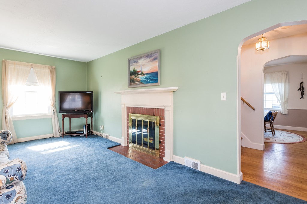 40 Oregon Street Springfield, MA 01118 - Photo 17 of 30 a living room with furniture and a fireplace