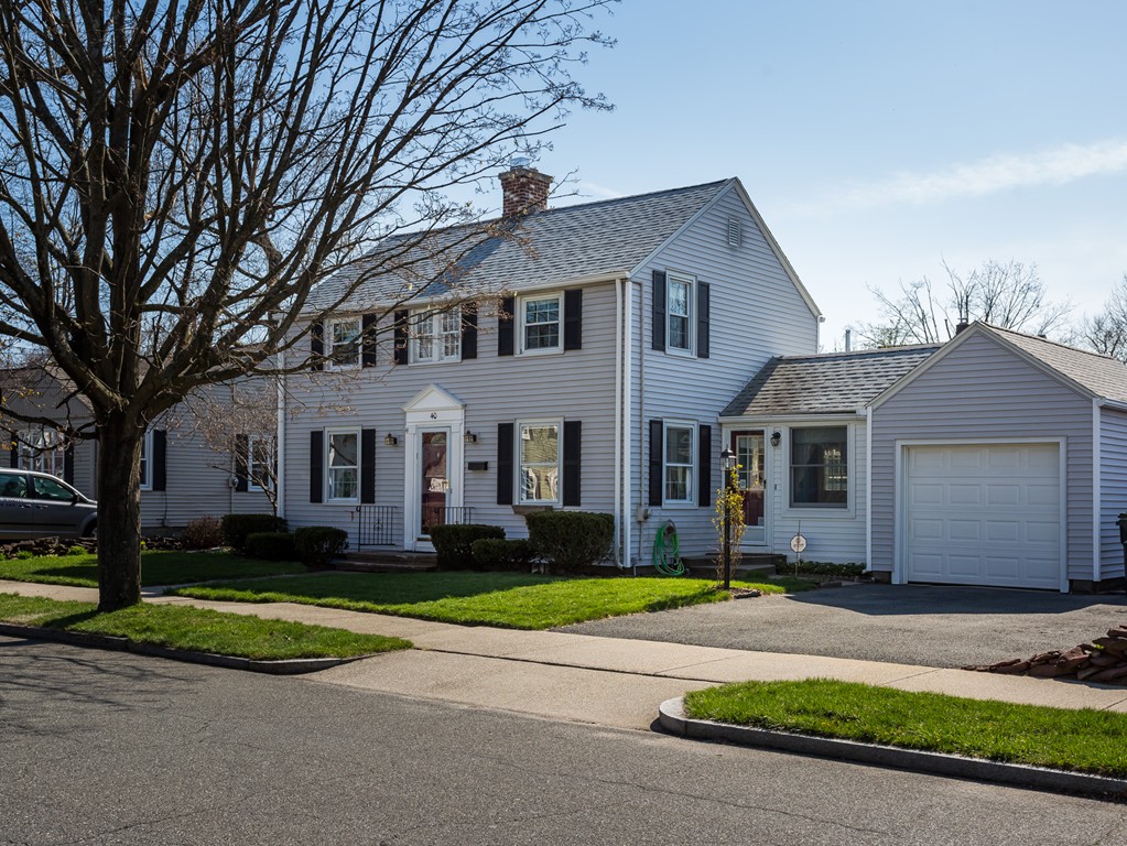 40 Oregon Street Springfield, MA 01118 - Photo 2 of 30 a front view of a house with a yard and garage