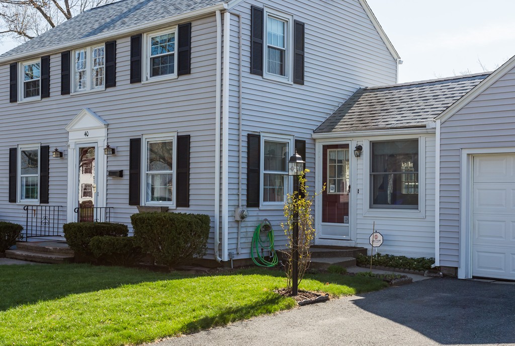 40 Oregon Street Springfield, MA 01118 - Photo 3 of 30 a front view of a house with garden and plants