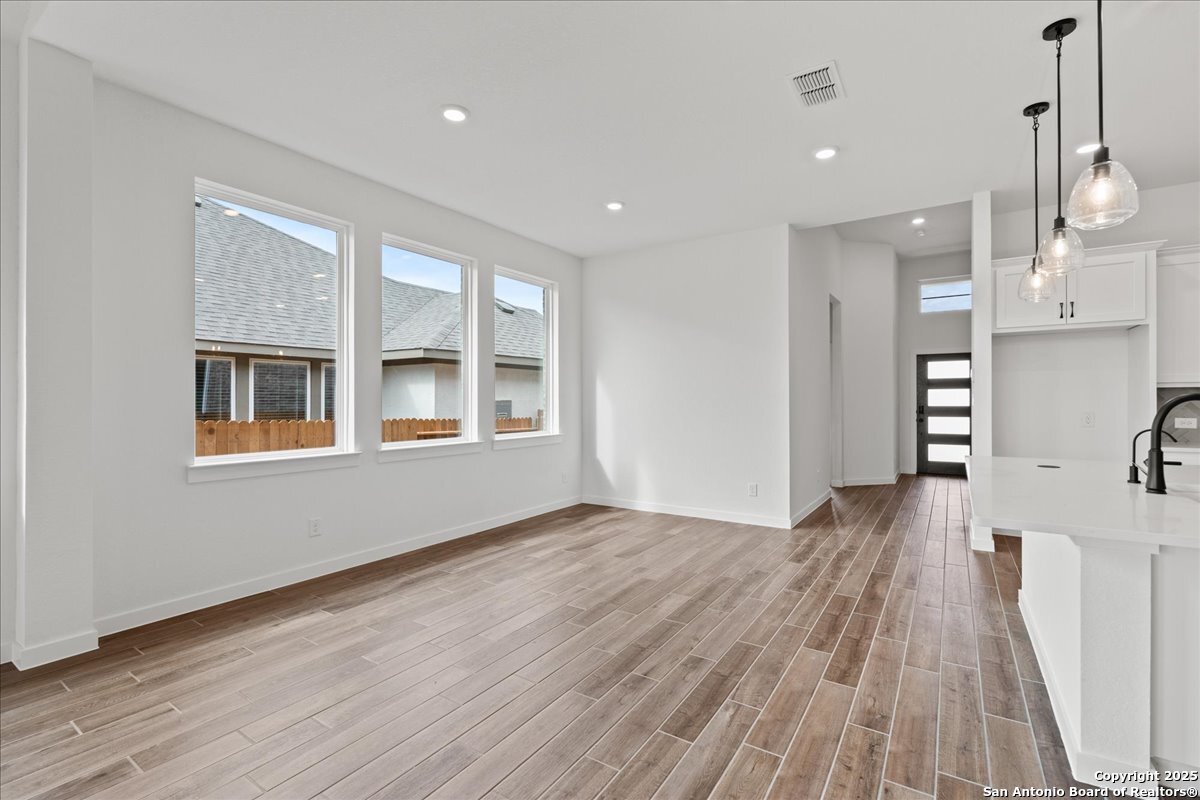 2013 Shepards Street Seguin, TX 78155 - Photo 7 of 21 a view of an empty room with wooden floor and a window