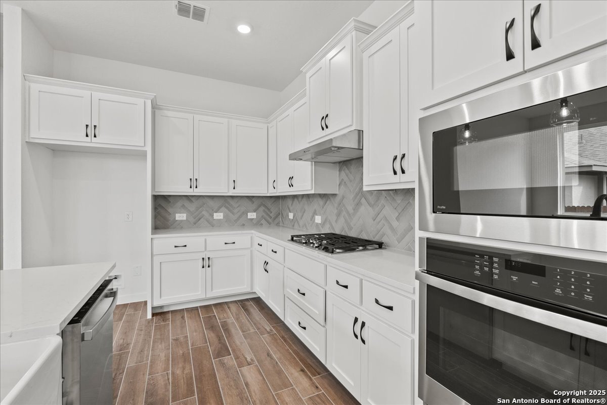 2013 Shepards Street Seguin, TX 78155 - Photo 8 of 21 a kitchen with stainless steel appliances white cabinets and stove