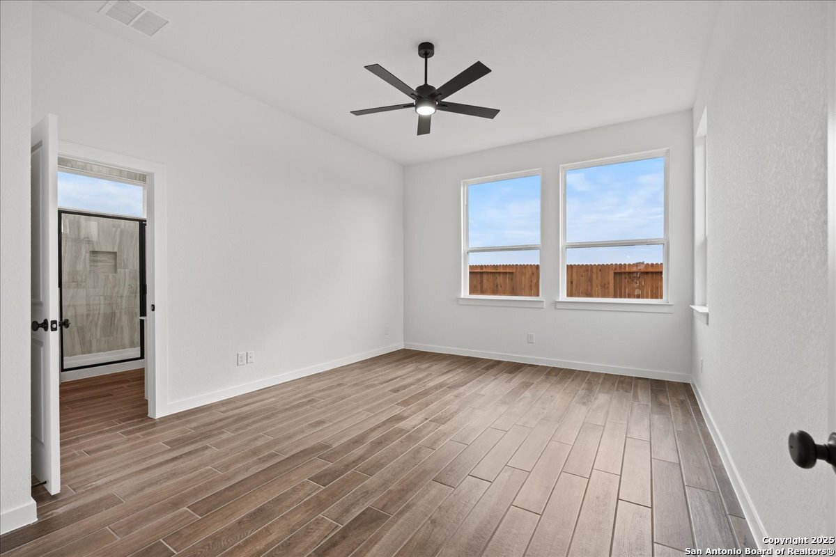 2013 Shepards Street Seguin, TX 78155 - Photo 9 of 21 a view of an empty room with wooden floor and a window