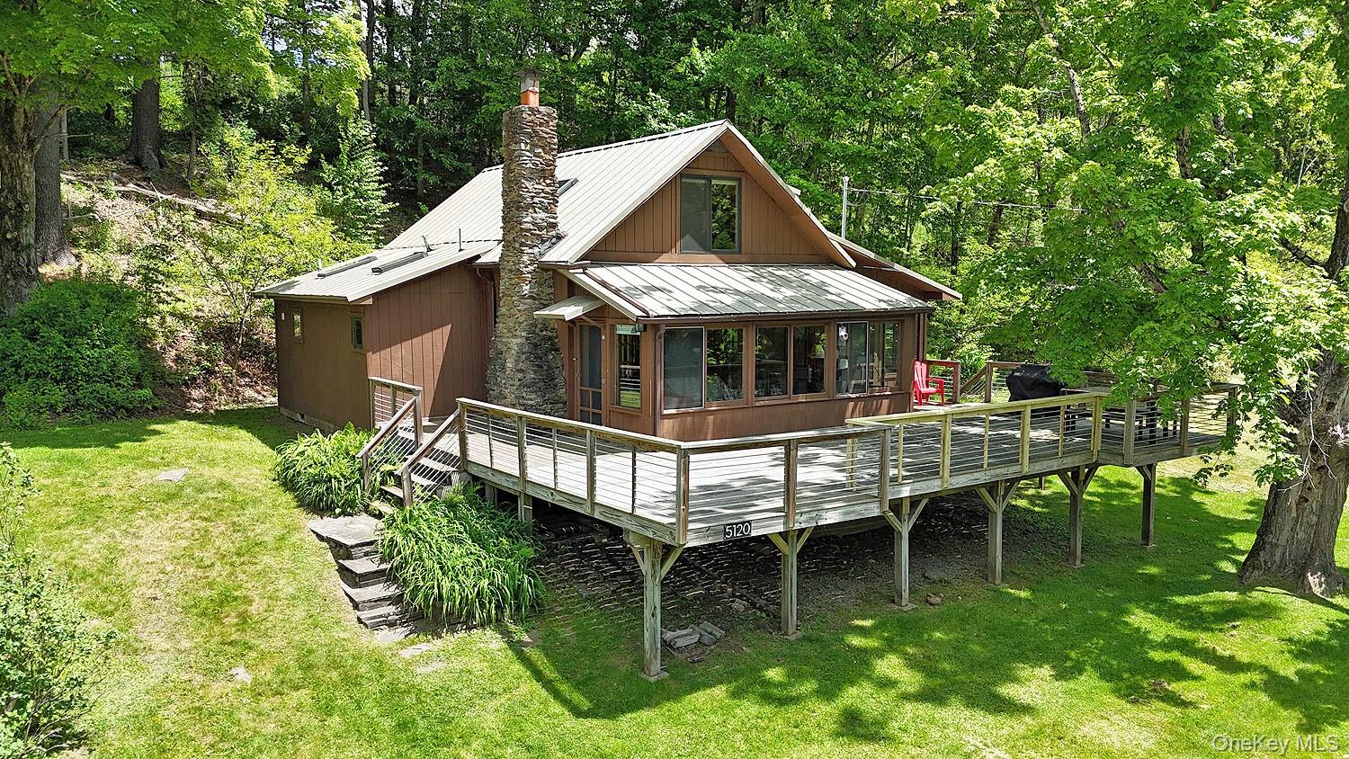 5120 Peas Eddy Road Hancock, NY 13783 - Photo 1 of 37 a roof deck with table and chairs potted plants and large tree