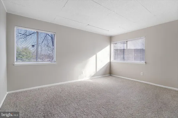 a bedroom with a bed and a large mirror