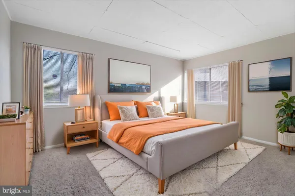 a bedroom with a bed and a large mirror