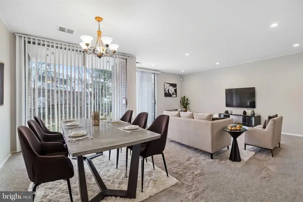 a view of a livingroom with furniture and a flat screen tv