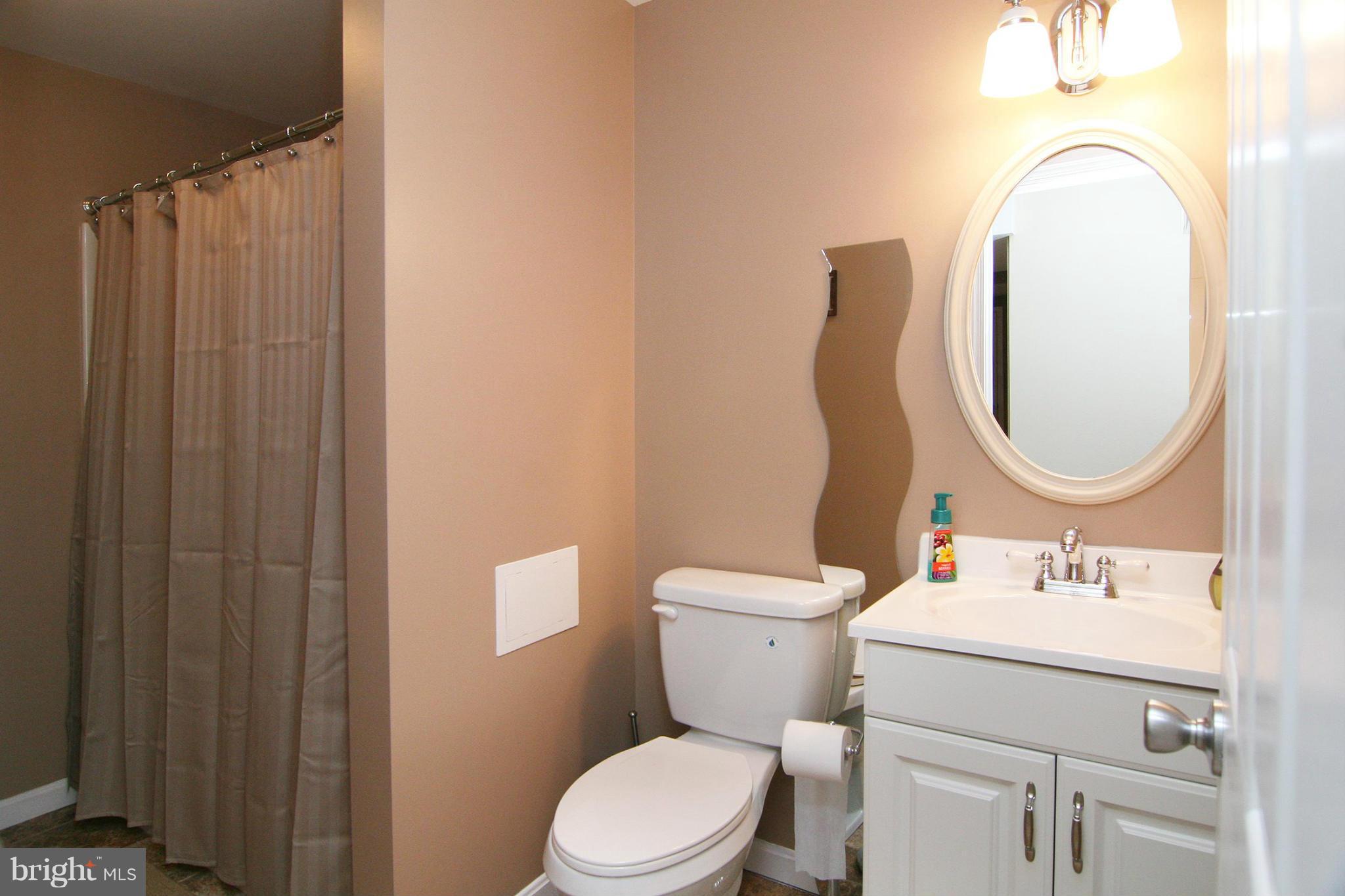 3200 Atlee Ridge Road New Windsor, MD 21776 - Photo 14 of 19 a bathroom with a toilet sink vanity and mirror