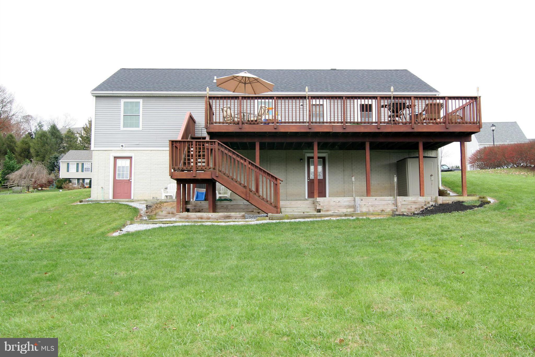 3200 Atlee Ridge Road New Windsor, MD 21776 - Photo 17 of 19 a view of a house with a backyard and deck