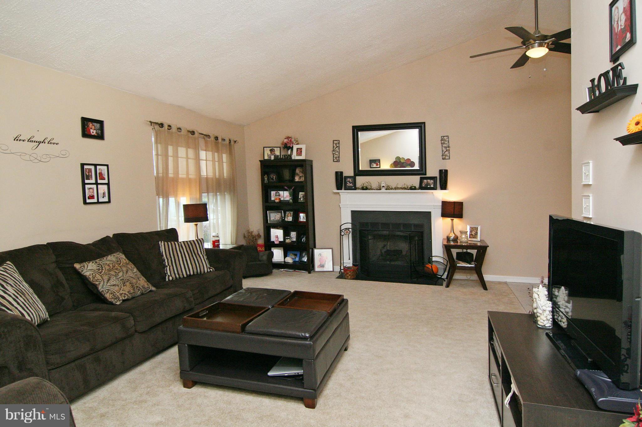 3200 Atlee Ridge Road New Windsor, MD 21776 - Photo 3 of 19 a living room with furniture a flat screen tv and a fireplace