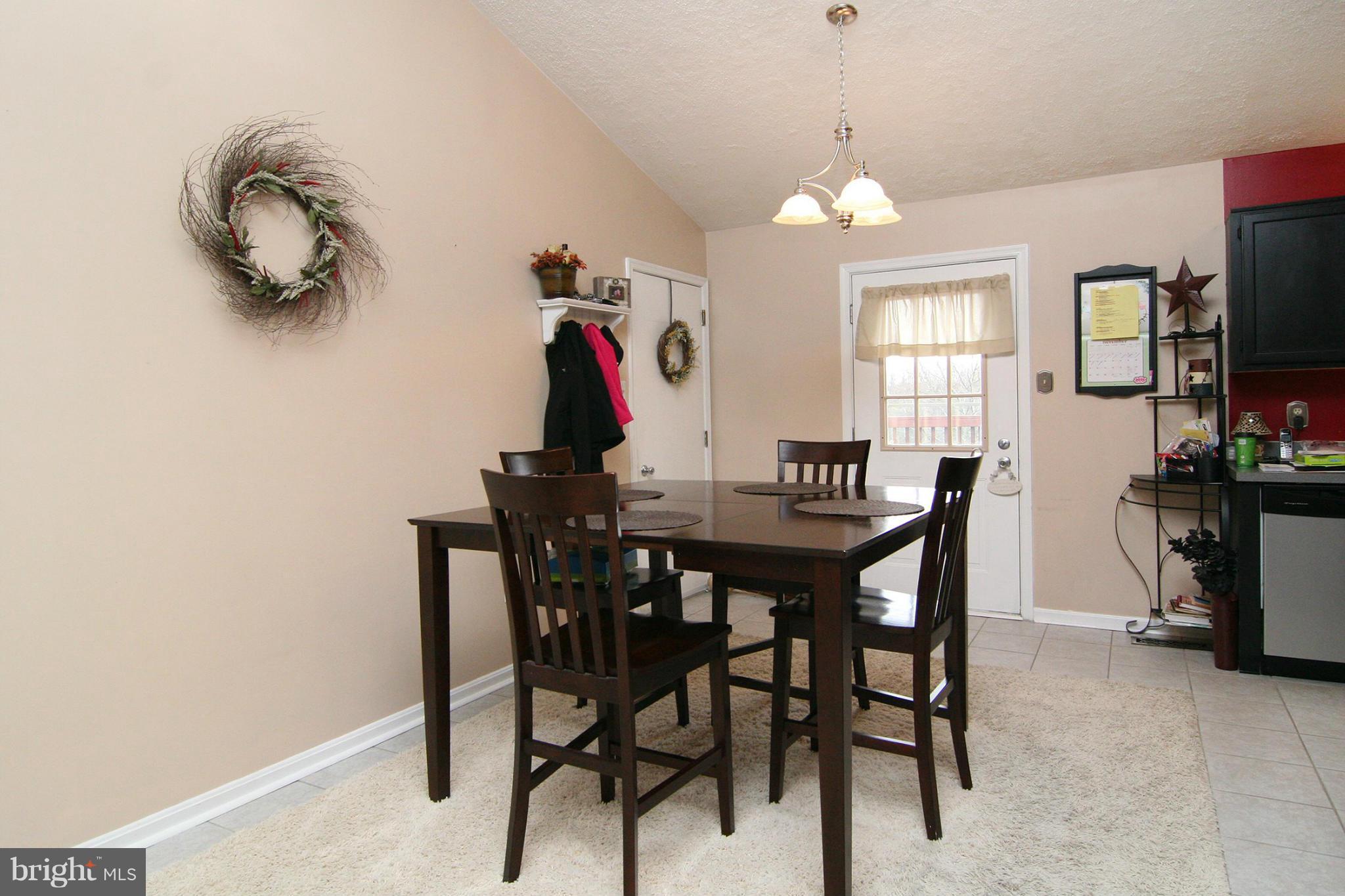 3200 Atlee Ridge Road New Windsor, MD 21776 - Photo 4 of 19 a view of a dining room with furniture and a chandelier