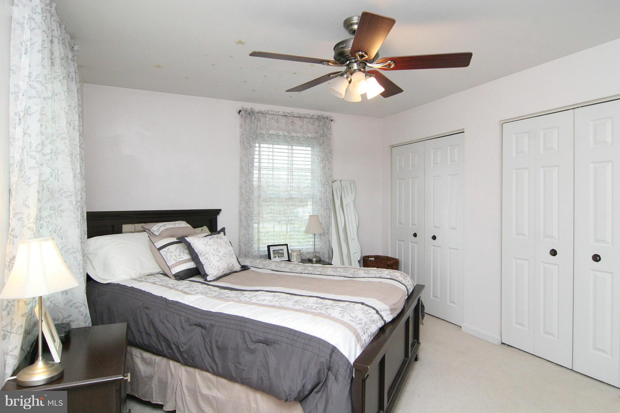3200 Atlee Ridge Road New Windsor, MD 21776 - Photo 10 of 19 a bedroom with a bed and a chandelier