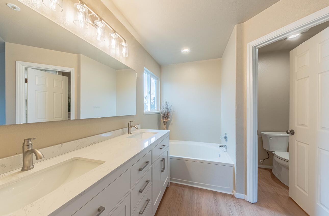 10 Rex Circle Salinas, CA 93906 - Photo 27 of 43 a bathroom with a tub a double vanity sink and mirror