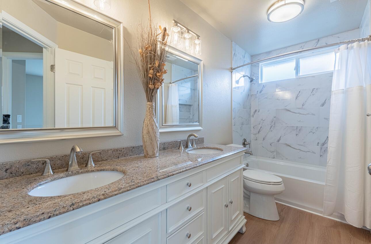 10 Rex Circle Salinas, CA 93906 - Photo 36 of 43 a bathroom with a granite countertop double vanity sink a mirror and a bathtub