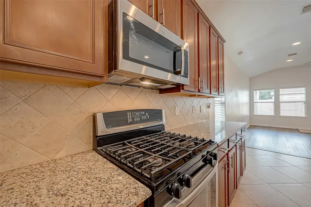 a stove top oven sitting inside of a kitchen