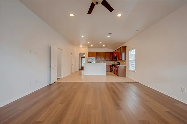 a view of a kitchen with a sink and wooden floor