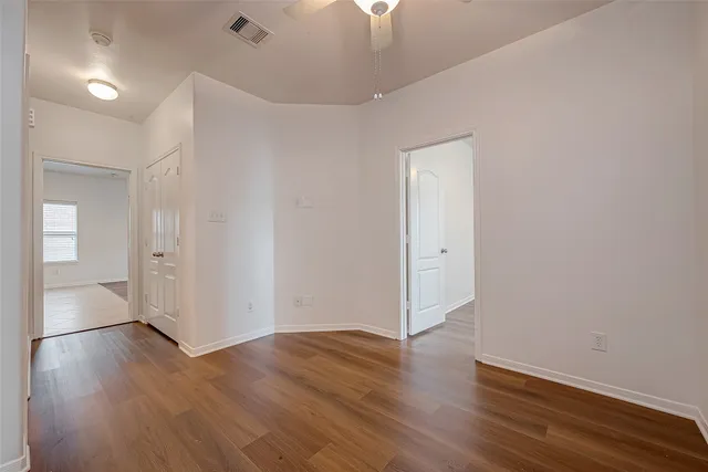 wooden floor in an empty room with a window