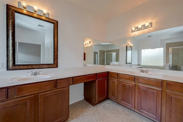 a bathroom with a double vanity sink and a mirror