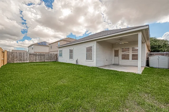 a view of a house with a backyard